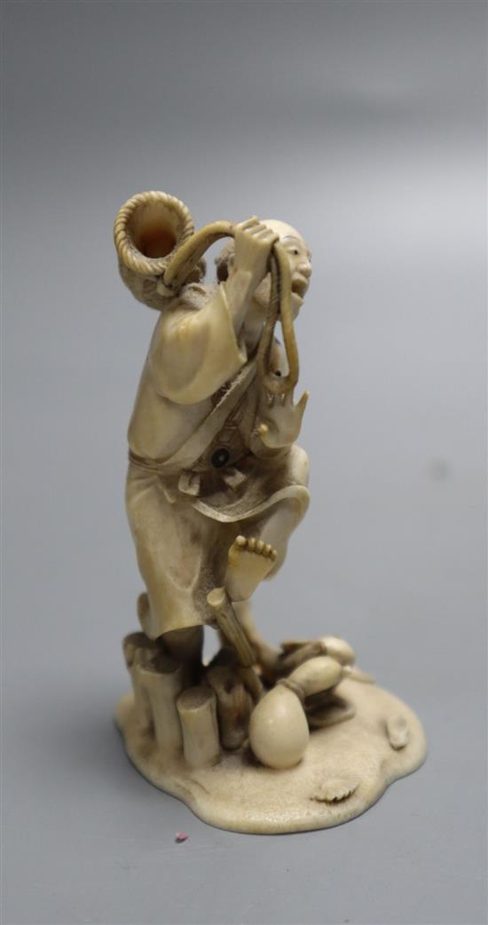 A fine 19th century Japanese ivory okimono of a fisherman startled by a fish, meiji period, height 8cm